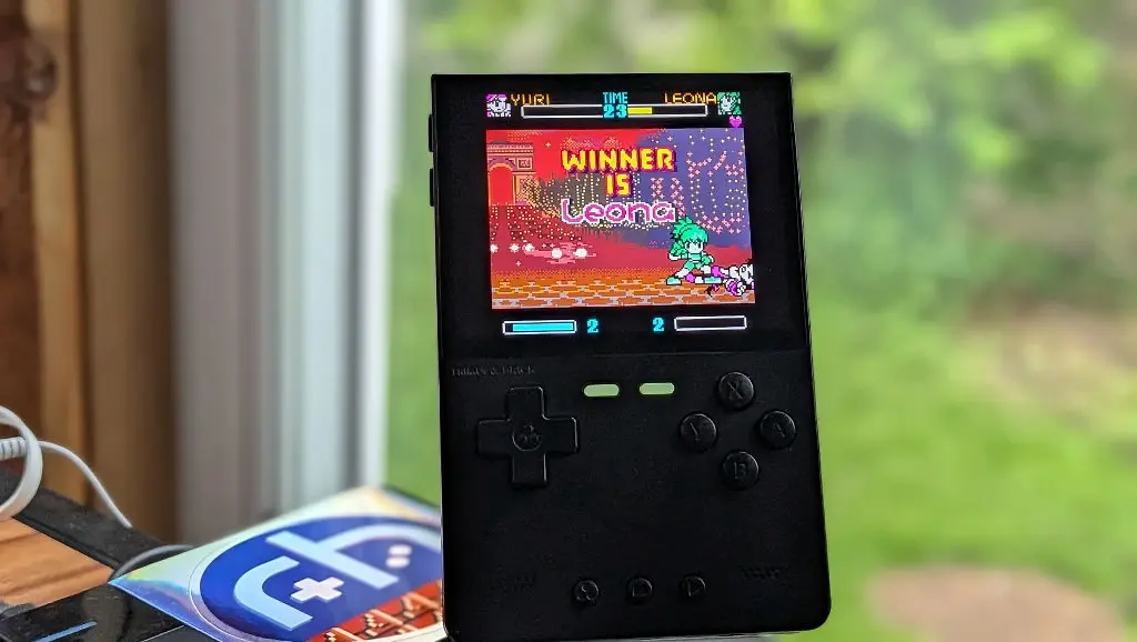 Anbernic RG Slide handheld with 4.7-inch screen showing NGPC game at 6x scale