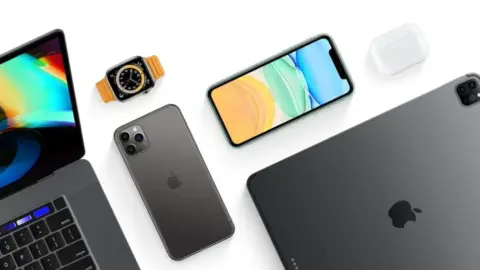 Apple iPhone and Mac devices on a desk