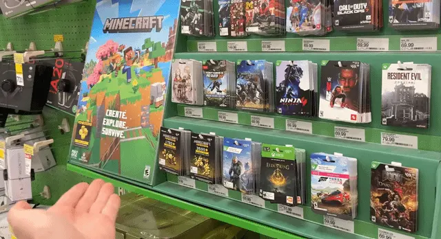 Retail display showing digital download code cards replacing physical game cases