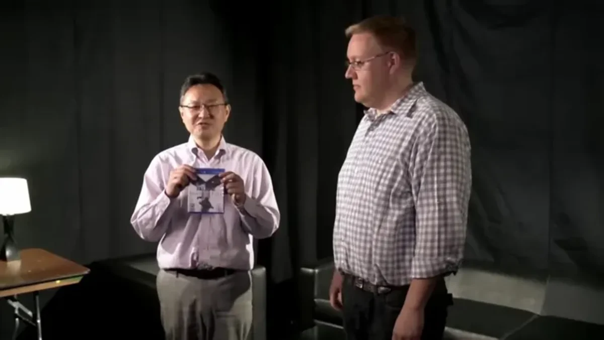 Shuhei Yoshida and Adam Boyes holding nothing at Tokyo Game Show