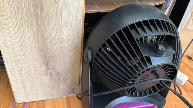 PS5 Pro internal components running in a cardboard box with an external fan